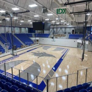 Athletes playing basketball on indoor hardwood sports flooring