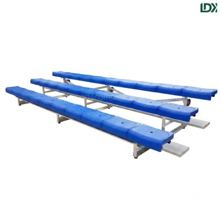 3-row freestanding aluminum sports bleachers with blue plastic seats isolated on a white background.