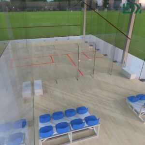Aerial interior view of glass squash court with red court lines and bleacher seating