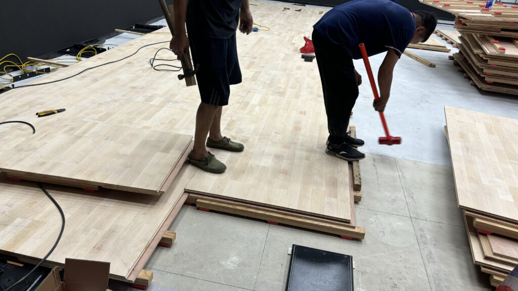 squash court hardwood sports flooring installation Installation of shock-absorbing maple hardwood sports flooring for an indoor squash court.